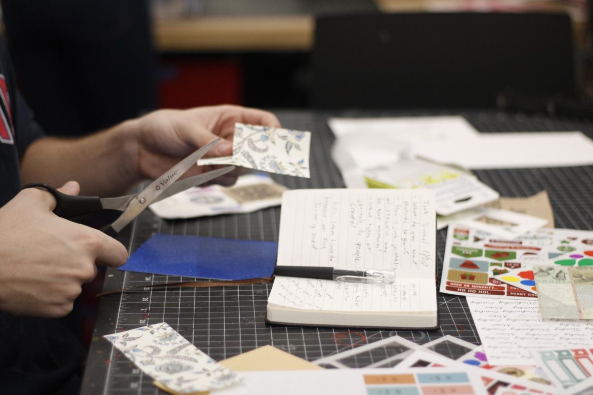 A student creates a junk journal in Hillman Library on Wednesday, Nov. 20. 