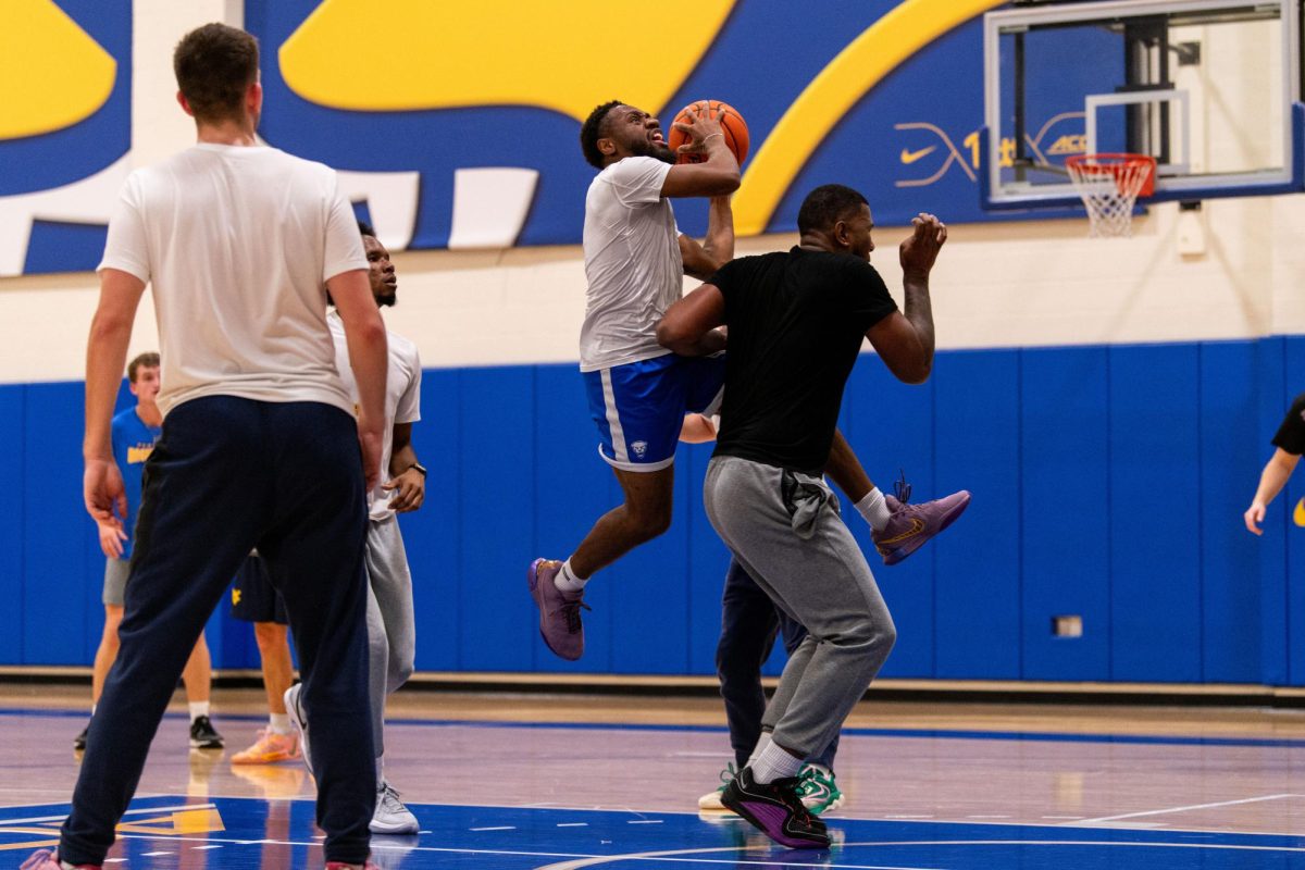 Pitt team manager KJ Marshall attempts a layup during the Pitt manager’s game against the West Virginia managers on Thursday, Nov. 14, 2024, on the  Pitt basketball practice court.