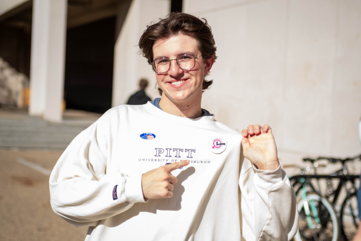 William Beddick, a senior public and professional writing and communications student, smiles for a picture outside Posvar Hall after voting on Tuesday, Nov. 5.