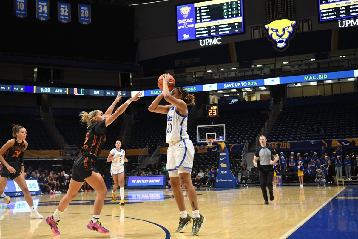 Redshirt sophomore Mikayla Johnson (23) prepares to shoot a 3-pointer during Pitt women’s basketball’s game against Miami on Sunday Dec. 14, 2024 at the Petersen Events Center.