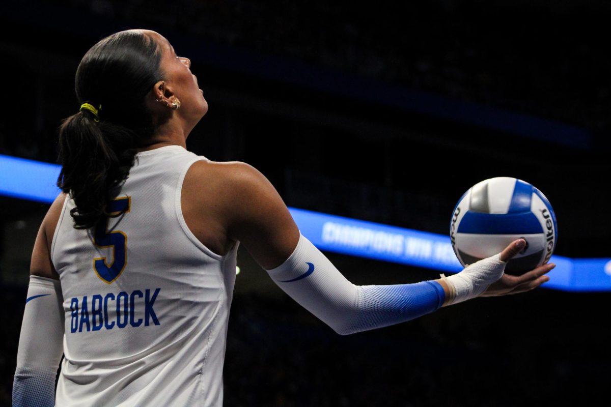 Sophomore opposite hitter Olivia Babcock (5) prepares to serve during the quarterfinals of the NCAA tournament on Saturday Dec. 14, 2024 at the Petersen Events Center.