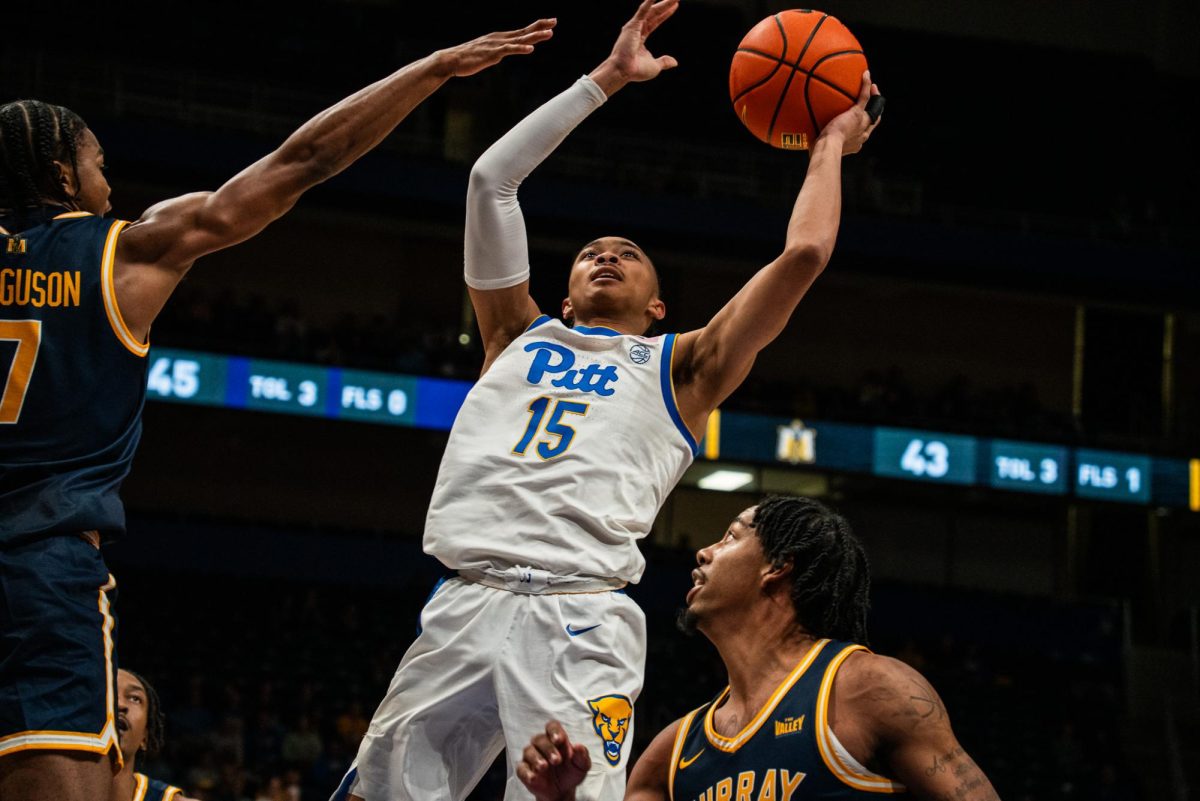 Sophomore guard Jaland Lowe (15) prepares to dunk the ball during the basketball game against Murray State in the Petersen Events Center on Saturday, Nov. 9.
