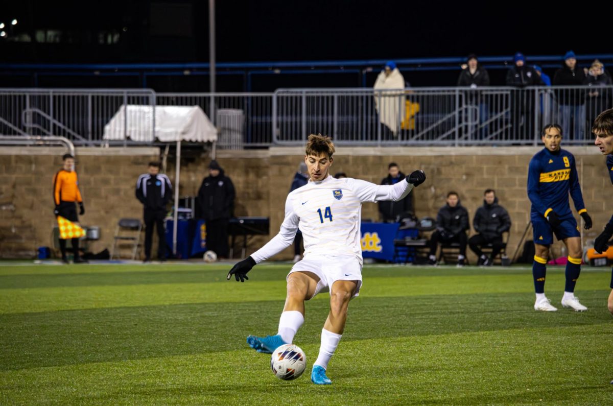 Graduate student midfielder Arnau Vilamitjana (14) kicks the ball during the soccer game against Kansas City at Ambrose Urbanic Field on Sunday, Dec. 1.
