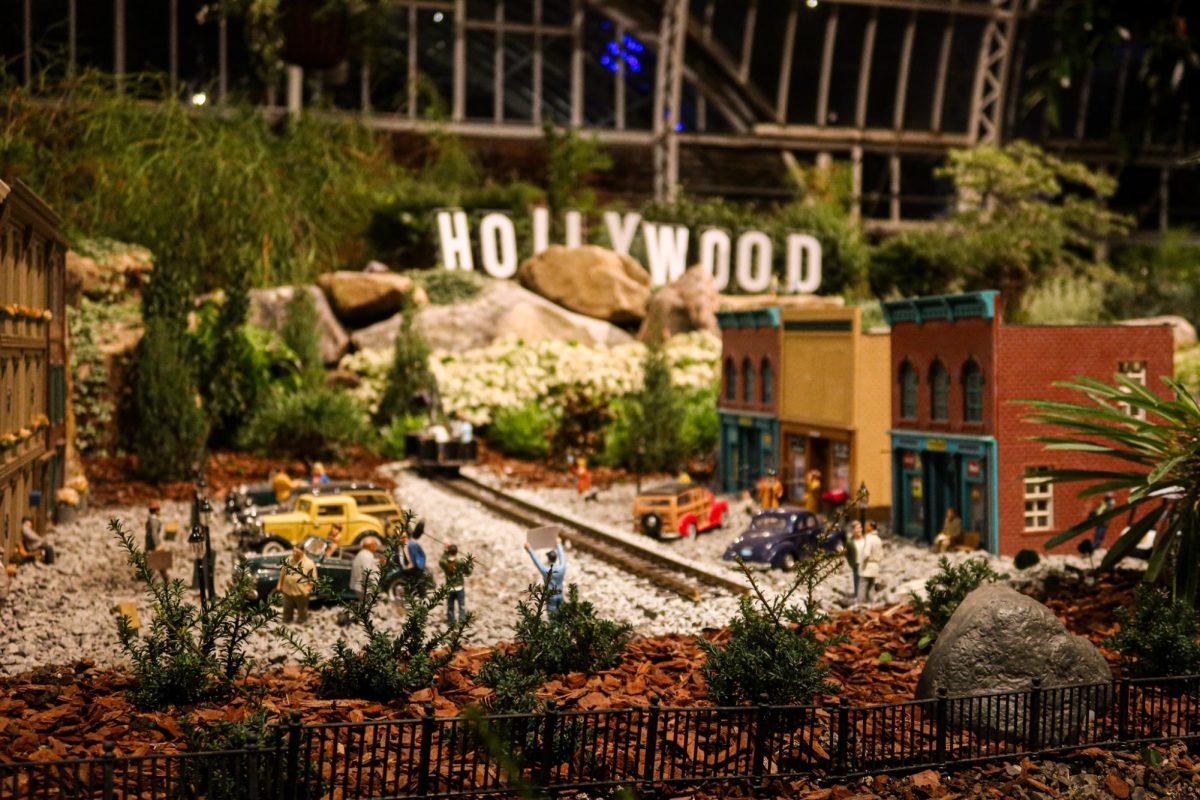 Mini-figures placed around a set in Phipps Conservatory’s Garden Railroad: Movie Magic display. 