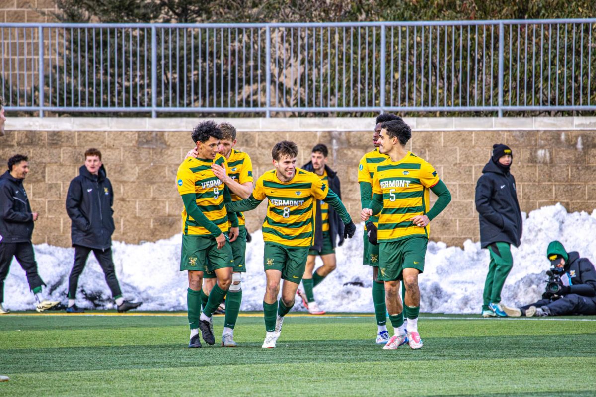 Vermont men's soccer celebrates together on Saturday Dec. 7.