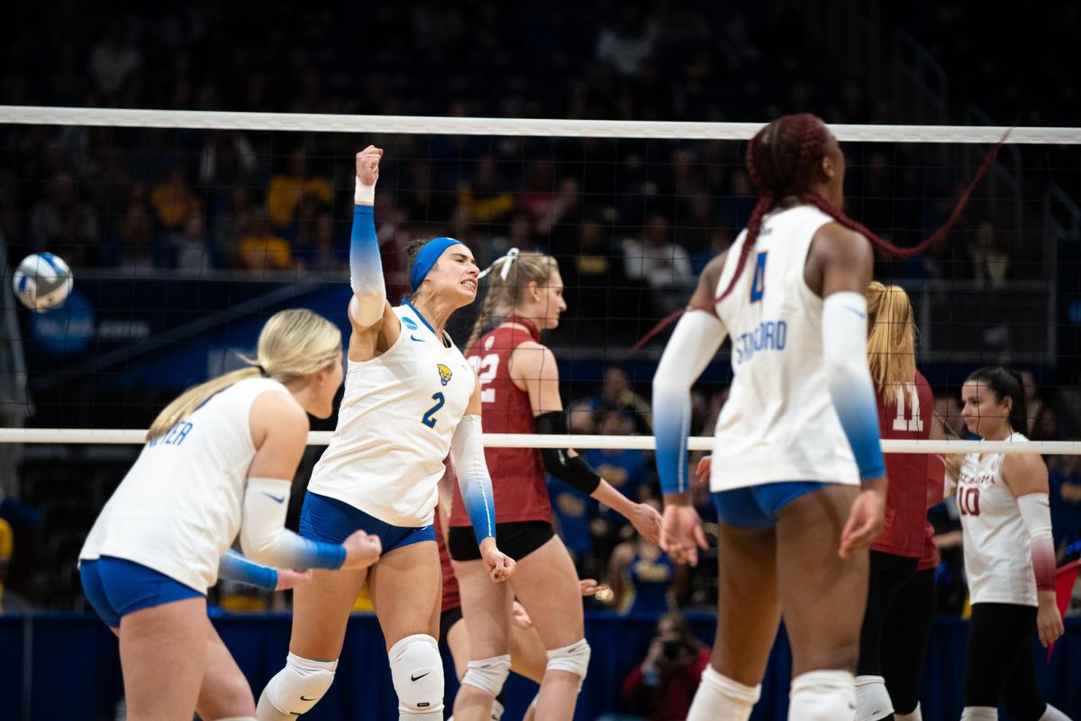 Pitt volleyball celebrates scoring a point in its match against Oklahoma on Saturday, Dec. 7