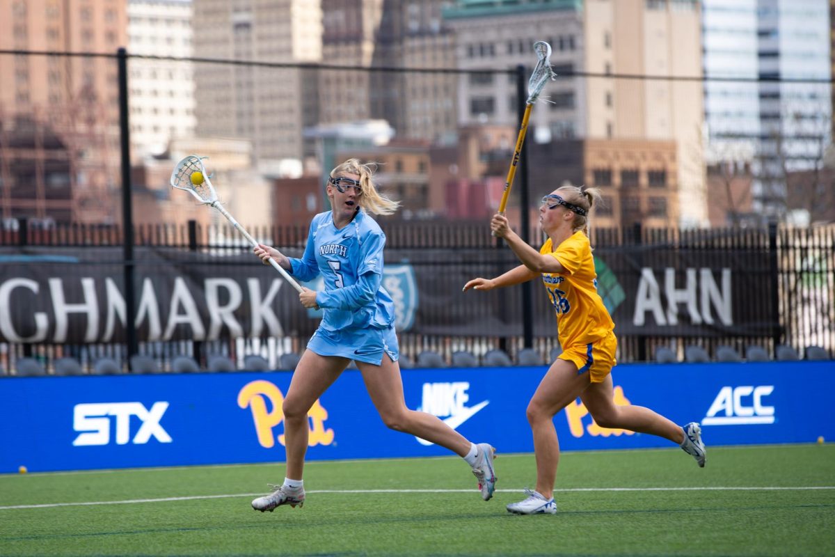 Junior attacker Jenna Hendrickson (36) chases after her opponent at the women’s lacrosse game versus UNC at Highmark Stadium on Saturday, Apr. 13.