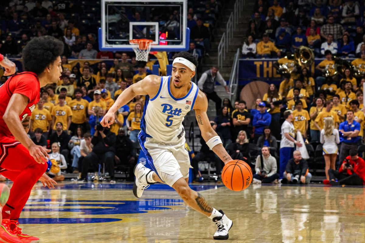 Senior guard Ishmael Leggett (5) drives the ball down the court during the men’s basketball game against Louisville in the Petersen Events Center on Saturday, Jan. 11.