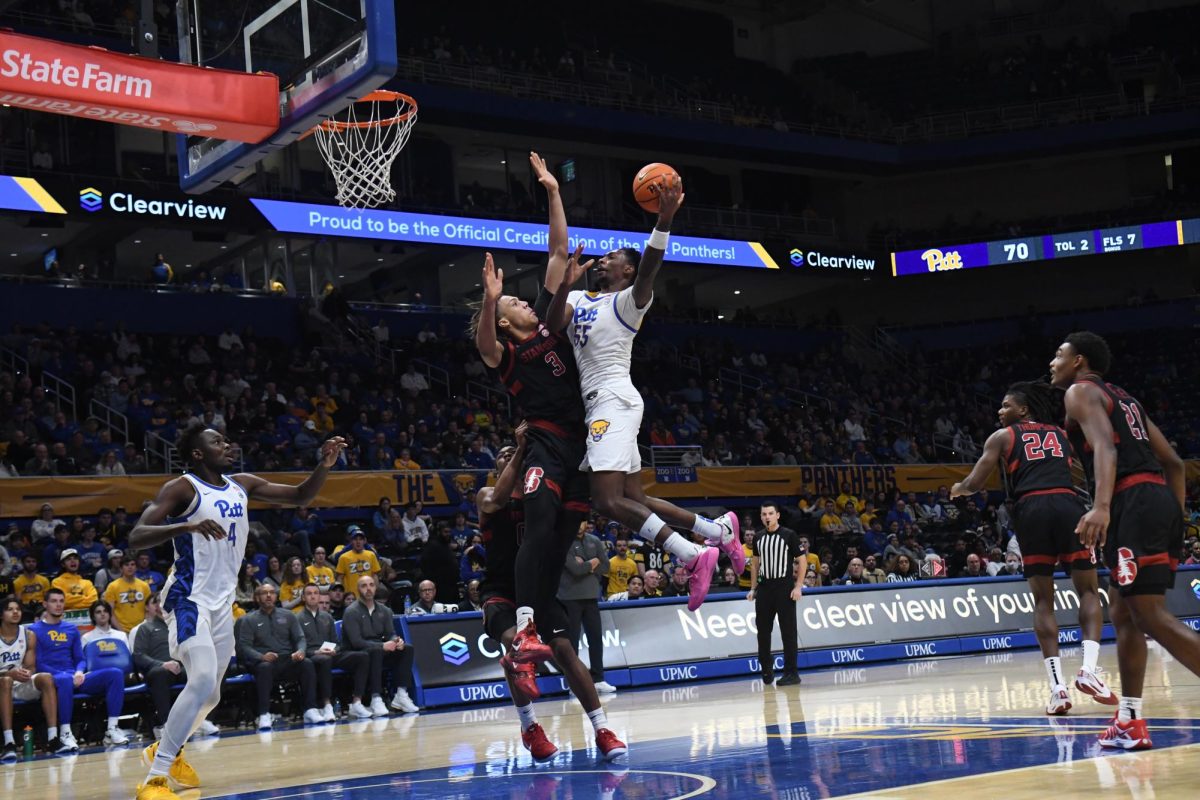 Redshirt senior forward Zach Austin (55) goes up for a layup during Pitt men’s basketball’s game against Stanford at the Petersen Events Center on Saturday, Jan. 5.