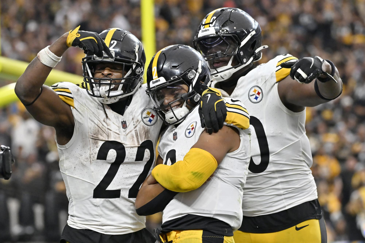 Pittsburgh Steelers quarterback Justin Fields, middle, is congratulated by running back Najee Harris (22) and tight end Darnell Washington after scoring against the Las Vegas Raiders during the second half of an NFL football game in Las Vegas, Sunday, Oct. 13, 2024.
