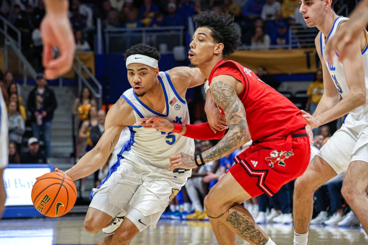 Senior guard Ishmael Leggett (5) drives the ball down the court during the men’s basketball game against Louisville in the Petersen Events Center on Saturday, Jan. 11.
