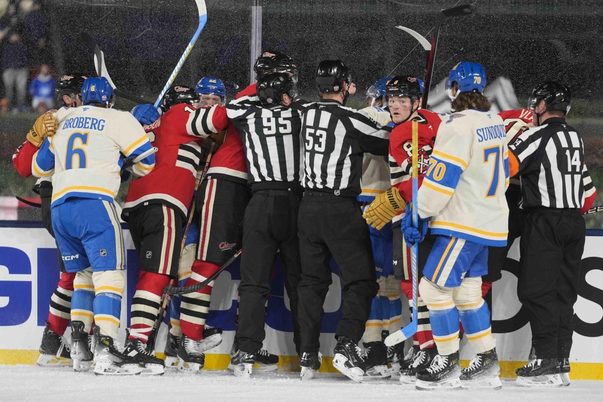 Officials break up a fight between the St. Louis Blues and Chicago Blackhawks during the second period of the NHL Winter Classic outdoor hockey game at Wrigley Field, Tuesday, Dec. 31, 2024, in Chicago.
