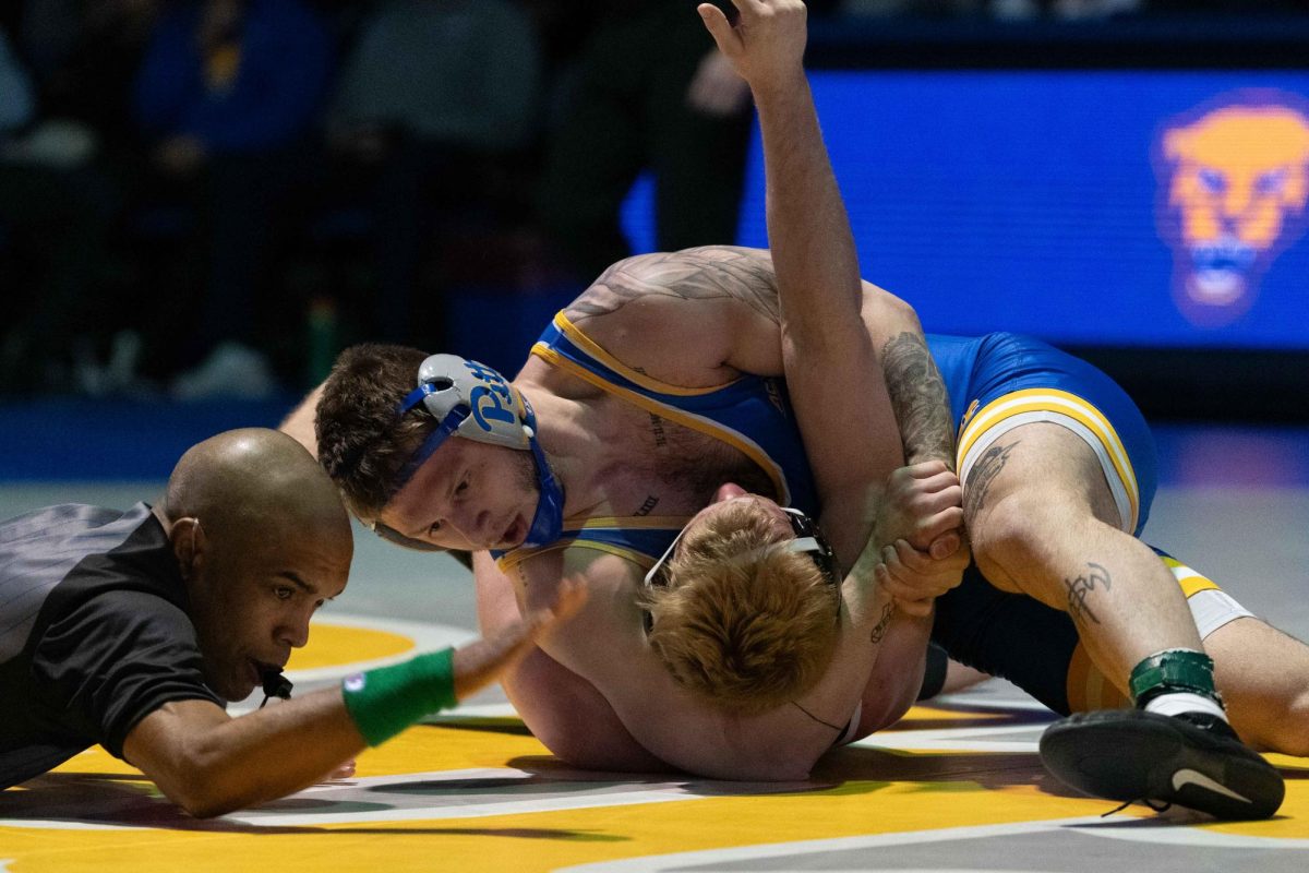 A referee mediates the wrestling match between Pitt and Duke in the Fitzgerald Field House on Saturday, Feb. 1.
