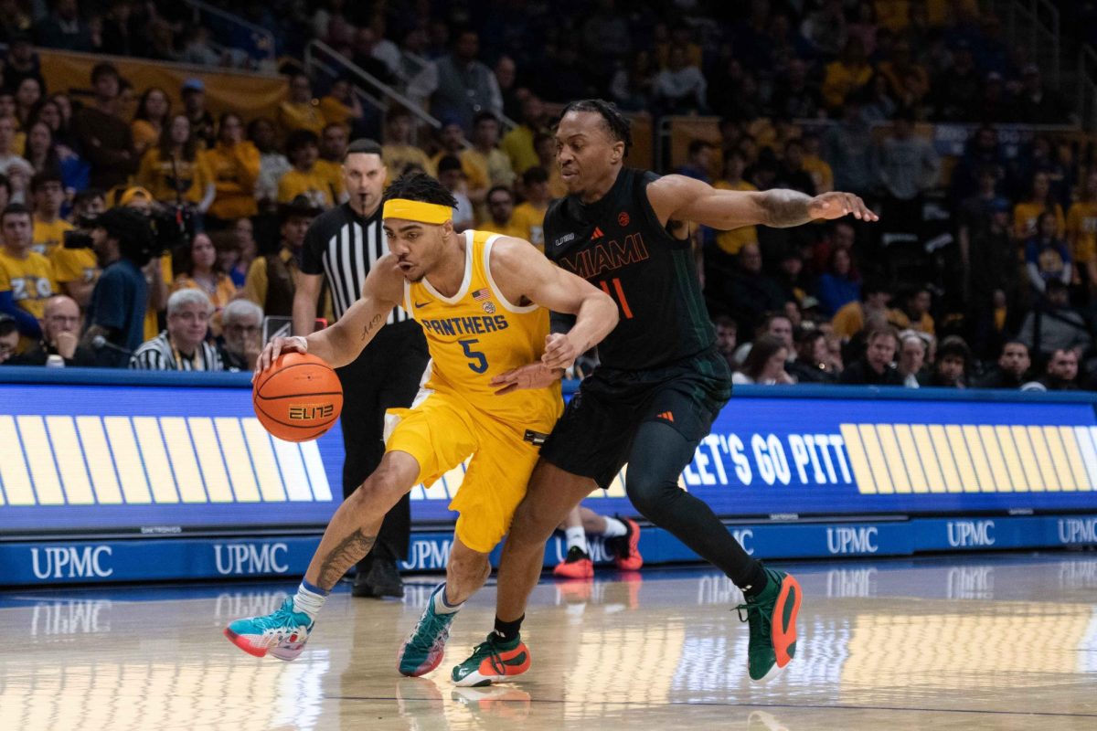 Senior guard Ishmael Leggett attempts to drive past Miami defense on Saturday, Feb. 15.