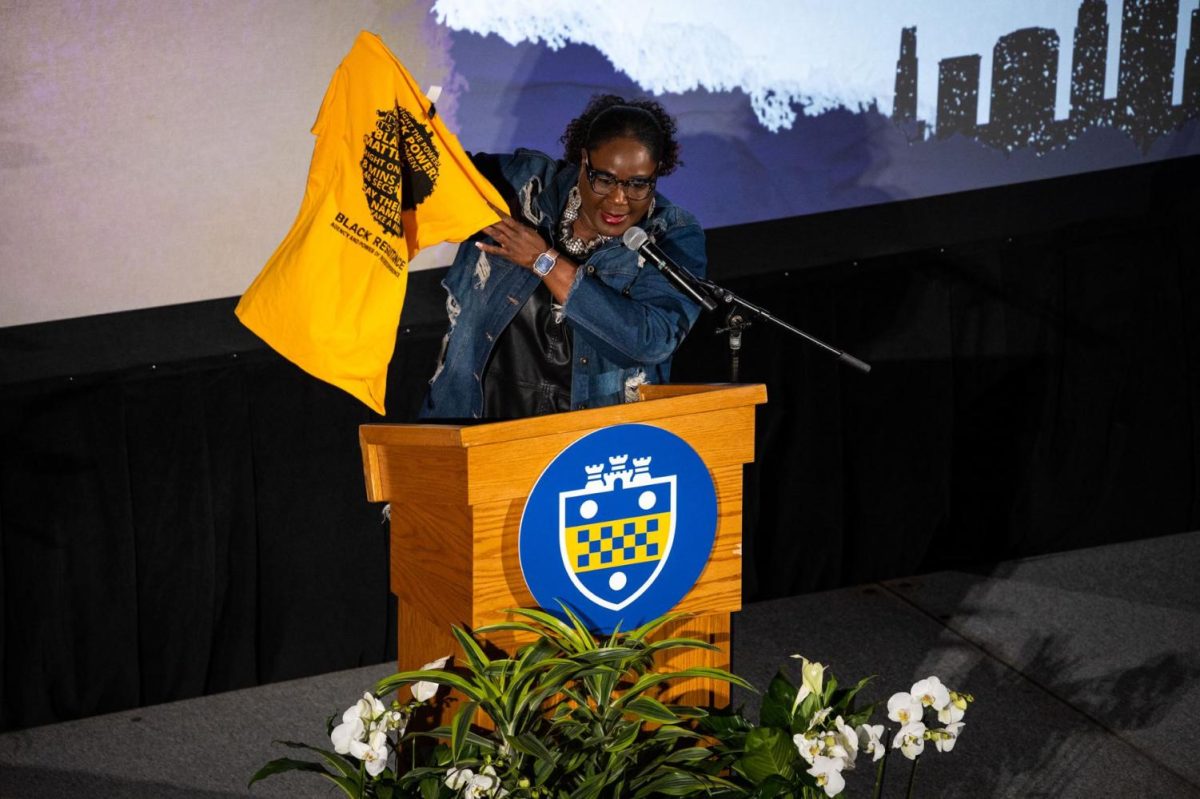 Linda Williams-Moore holds up a T-shirt during “A Night of Celebration: Honoring the Heroes of Black Resistance” on Wednesday, Feb. 22, 2023.
