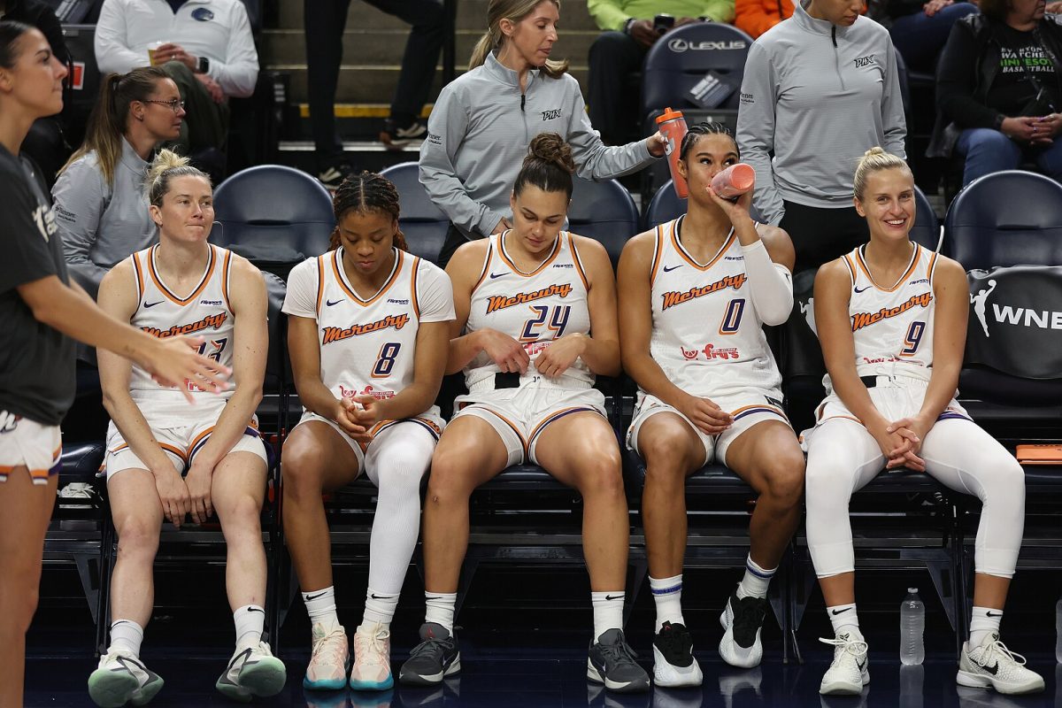 Phoenix Mercury players sit along the sideline at a game against the Minnesota Lynx on June 3, 2025.