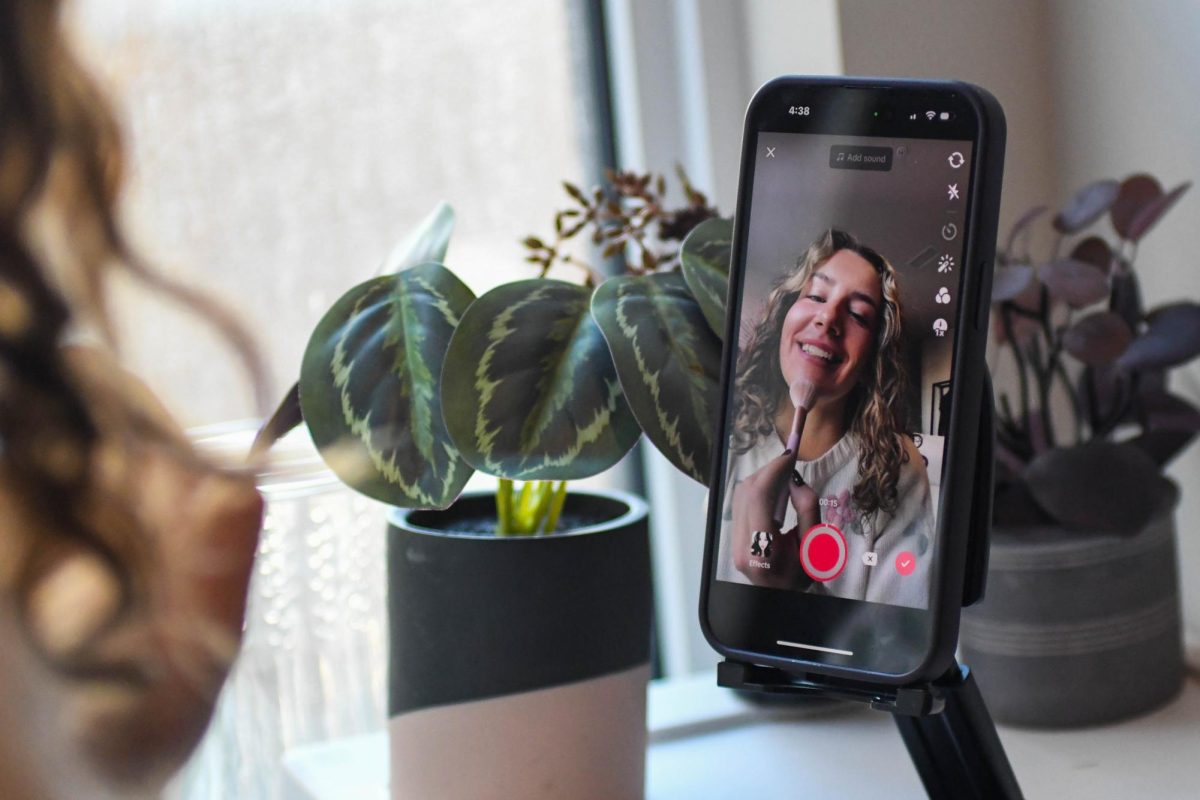 A Pitt student uses TikTok to film a makeup tutorial.
