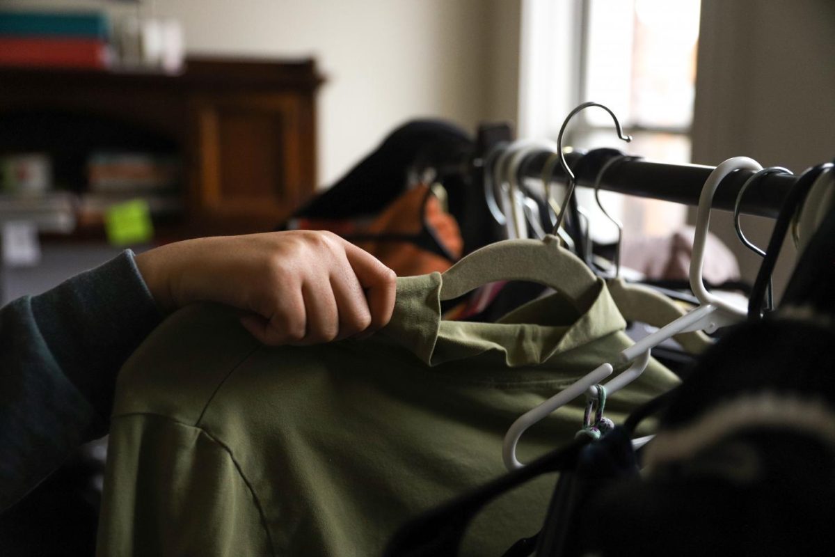 A Pitt student browses through a clothing rack.
