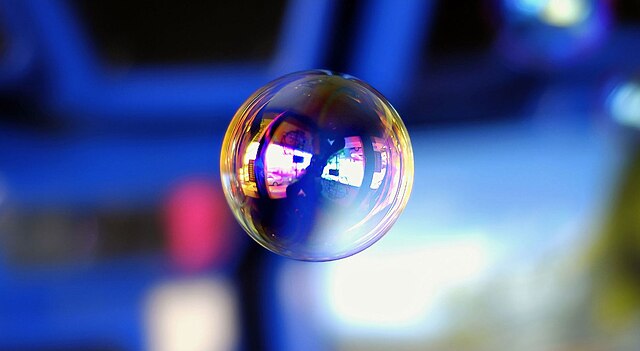 A soap bubble floats in the air.