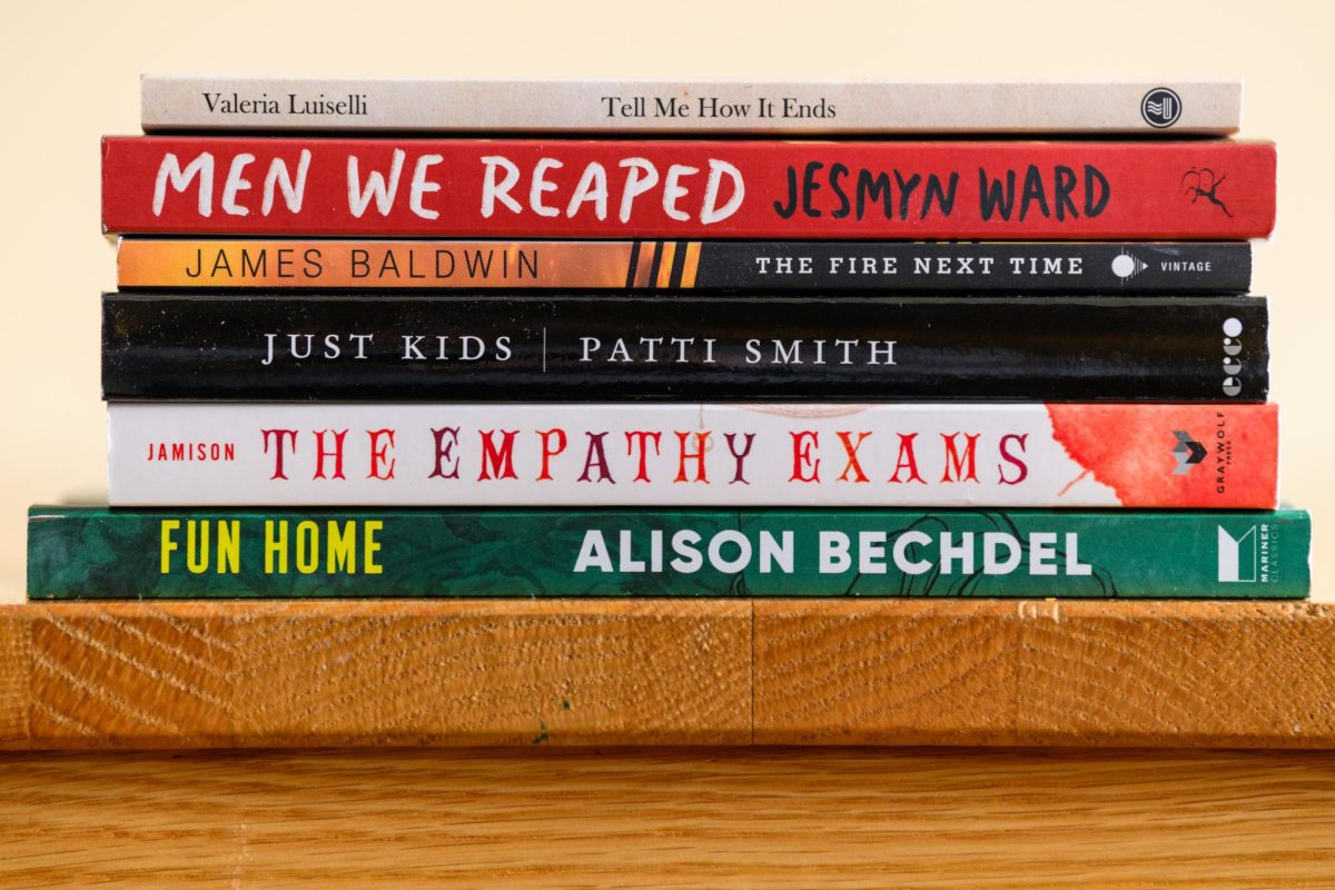 A stack of books on a bookshelf. 
