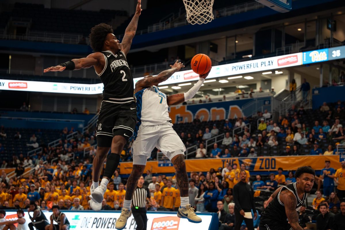 Pitt basketball fifth-year Damarco Minor (7) shoots a layup during a game against Providence at the Petersen Events Center on Oct. 19, 2025.
