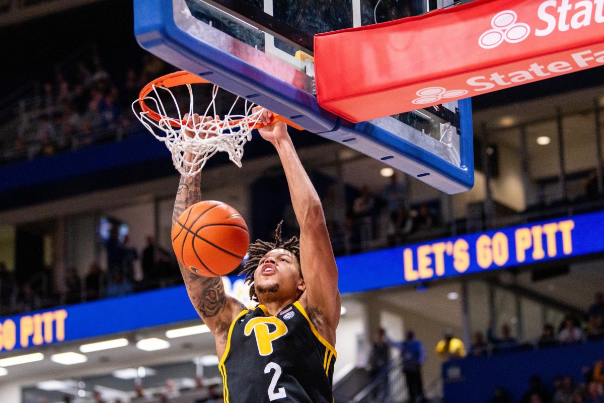 Senior forward Cameron Corhen (2) dunks the ball during the Pitt men’s basketball’s game against UNC at the Petersen Events Center on Jan. 28, 2025.
