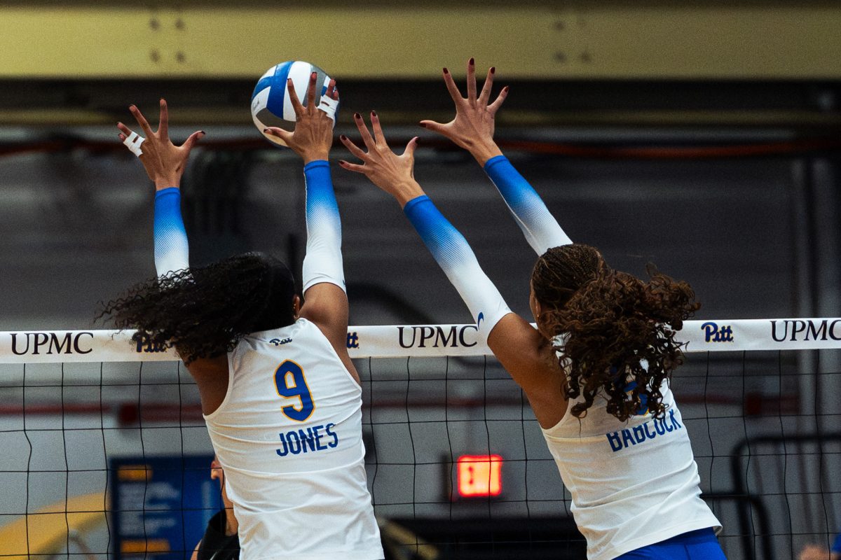 Sophomore Ryla Jones (9) and junior Olivia Babcock (5) attempt to block the ball during a Pitt volleyball game against Virginia Tech at the Fitzgerald Field House on Nov. 8, 2025.