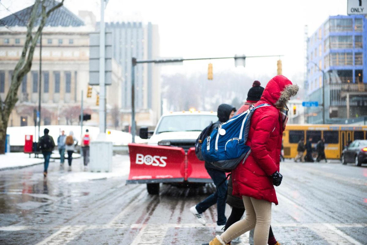 Students trudge through slush and light snow during the first day of spring semester classes on Jan. 8, 2018.