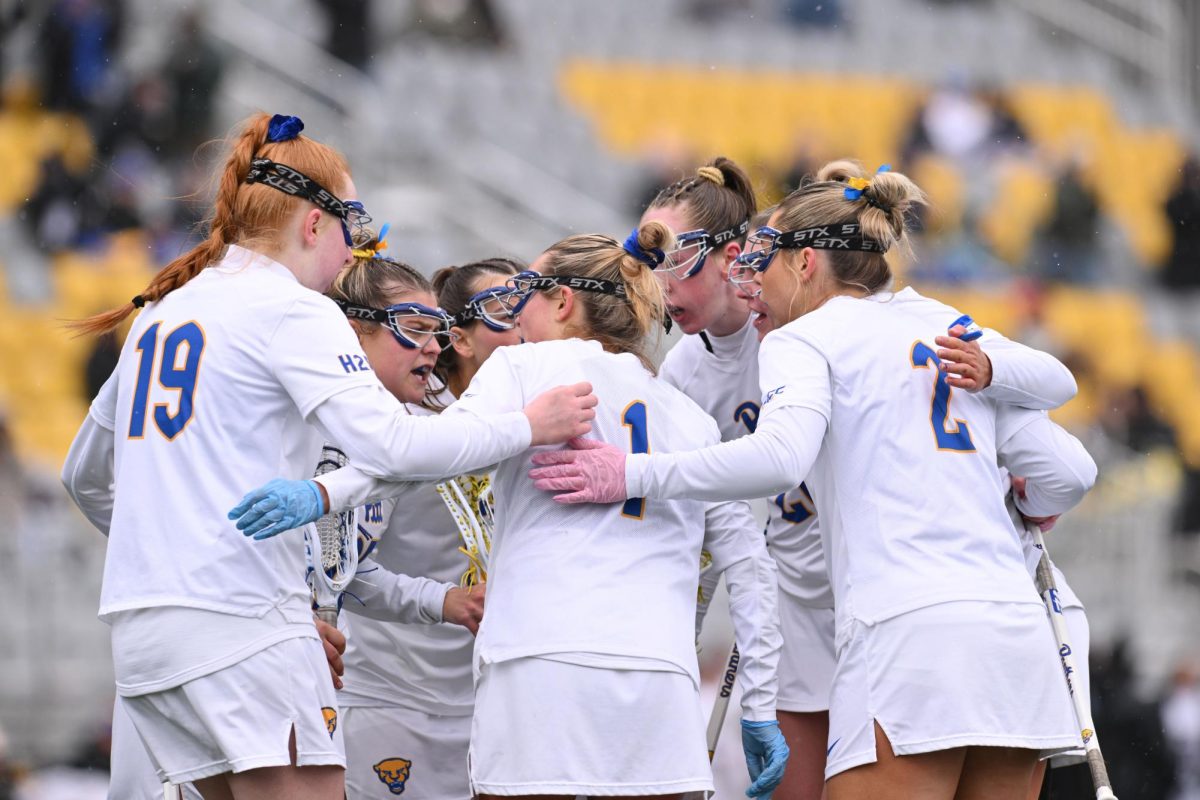 Members of the Pitt Women’s Lacrosse team huddled together during the game on Sunday. 
