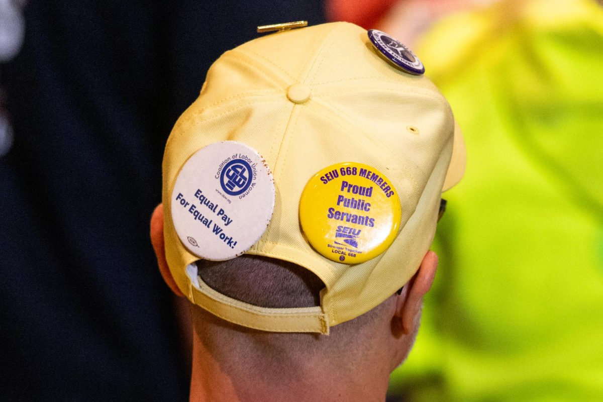 A union member wears SEIU pins on their hat before the rally at IBEW Local Union 5 on Sept. 2, 2024.