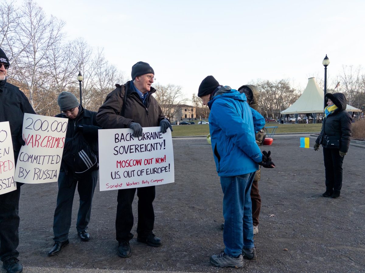 A protester holds up a sign to signal support for Ukraine on Tuesday.