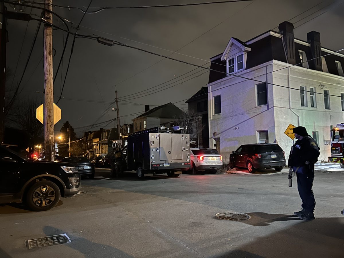 An officer stands near the scene of an incident on Juliet Street Monday night.