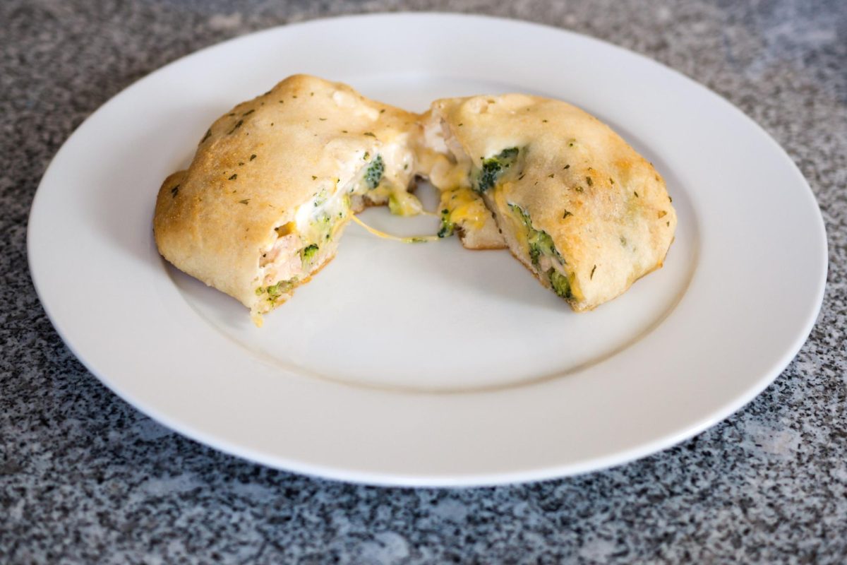 A chicken and broccoli Hot Pocket on a plate.