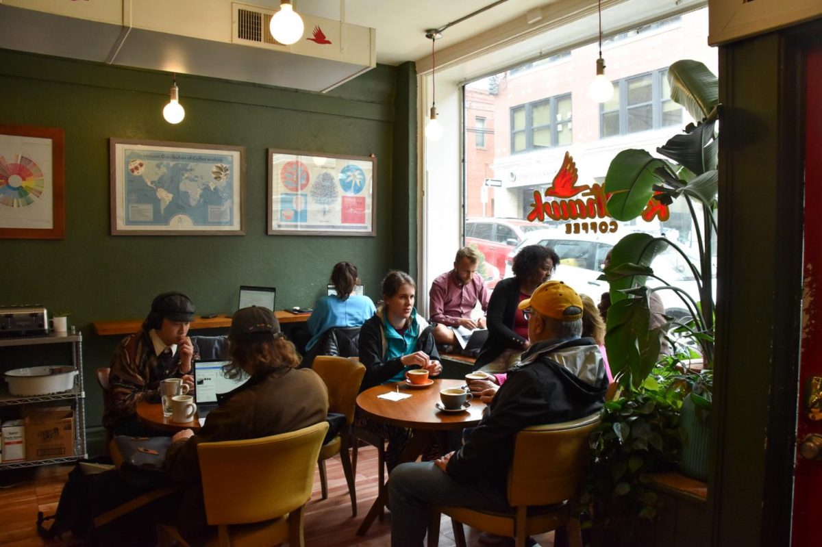People sit inside of Redhawk Coffee on Meyran Avenue.
