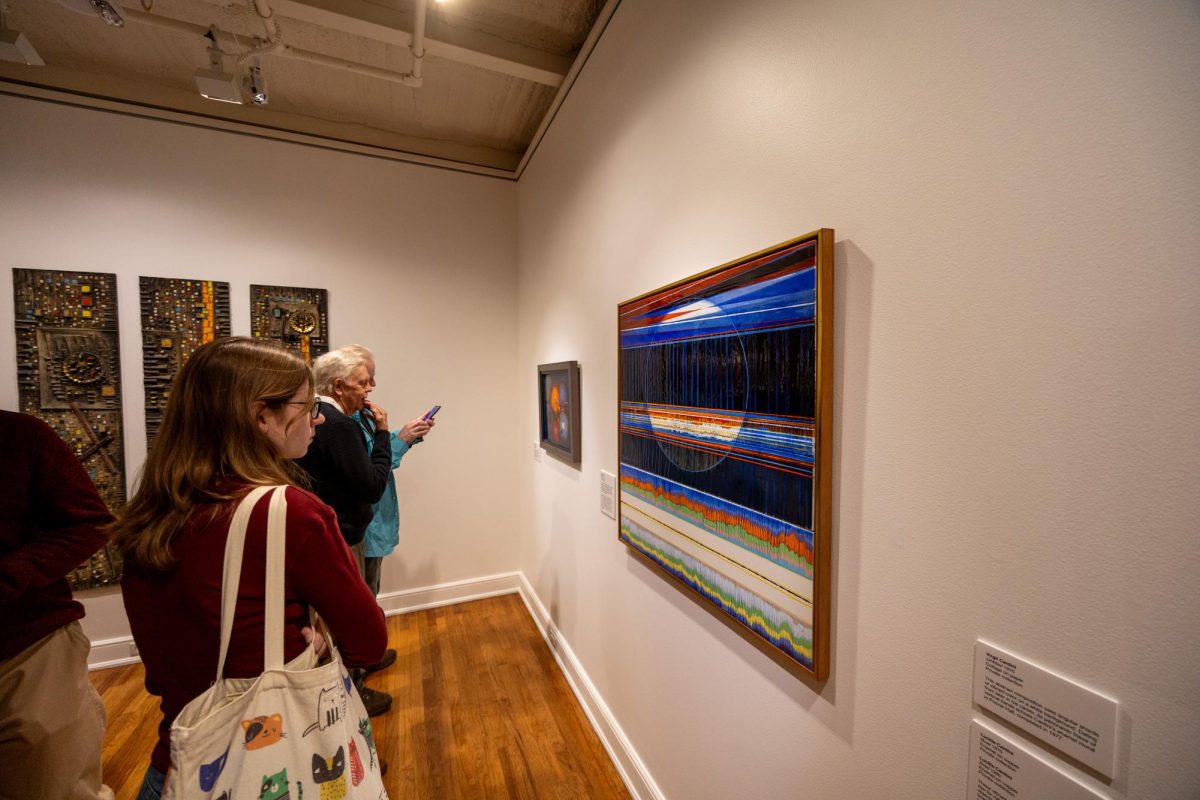 Attendees at an exhibition at the University Art Gallery.

